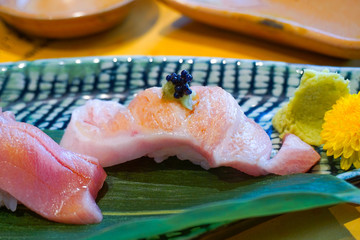close up fesh sliced raw tuna or Otoro or Fatty Tuna sushi on the dish. Japanese traditional food. Selective focus.