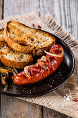 Grilled sausage, toasts and mushrooms