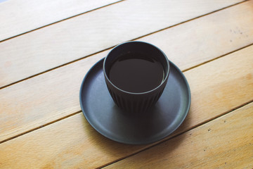 cup of coffee on wooden table