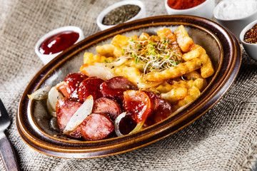 Grilled sausages, French fries and vegetables