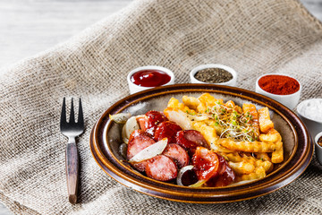 Grilled sausages, French fries and vegetables