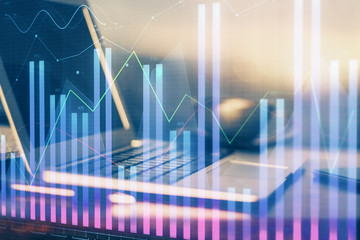 Financial chart drawing and table with computer on background. Multi exposure. Concept of international markets.