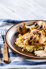 Potato cakes with chopped pork, gravy sauce and champignon