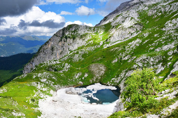 Abkhazia, lake Dzou in the mountains in summer in cloudy weather