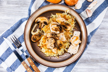 Potato cakes with chopped pork, gravy sauce and champignon