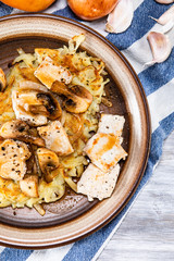 Potato cakes with chopped pork, gravy sauce and champignon