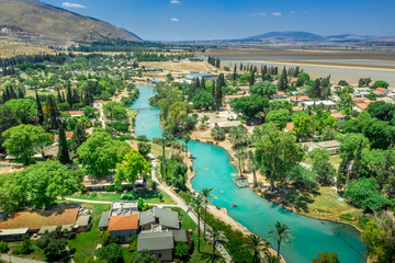 Turquoise Amal river running through the traditionally agriculture based collective community...