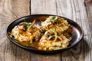 Potato cakes with gravy sauce and champignon