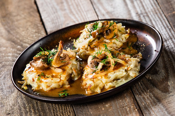 Potato cakes with gravy sauce and champignon