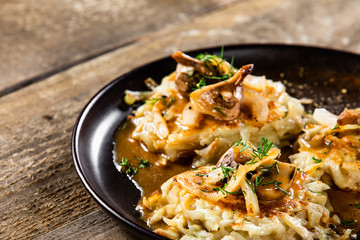 Potato cakes with gravy sauce and champignon