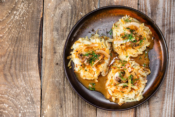 Potato cakes with gravy sauce and champignon