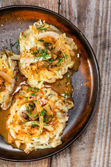 Potato cakes with gravy sauce and champignon