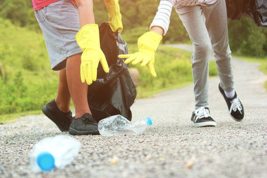 Group of kids volunteer help garbage collection charity environment, selective soft focus.