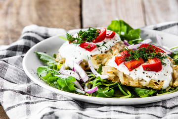 Potato cakes with sour cream and vegetables