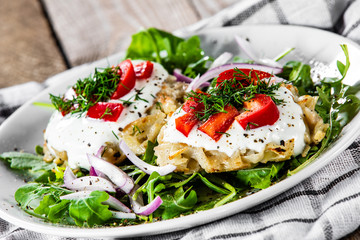 Potato cakes with sour cream and vegetables