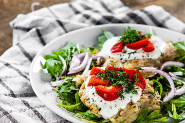 Potato cakes with sour cream and vegetables