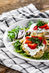 Potato cakes with sour cream and vegetables