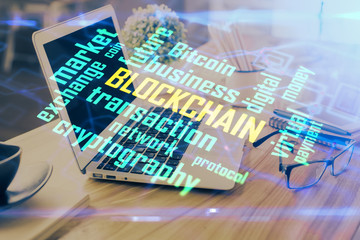 Fototapeta premium Double exposure of blockchain and crypto economy theme hologram and table with computer background. Concept of bitcoin cryptocurrency.
