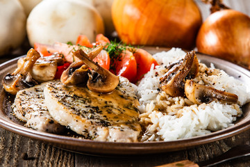Grilled pork chop with white rice and mushroomson 