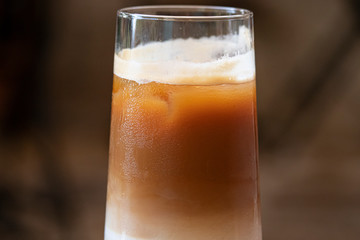 Delicious iced cafe latte on wooden table.