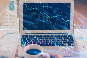 Financial market graph hologram and personal computer on background. Double exposure. Concept of forex.