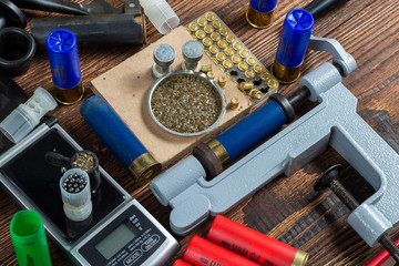 Shotgun shells reloading process with special reload equipment. Powder, bullets, fraction, shells,...