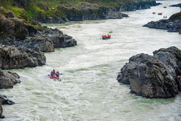 Several rafts and kayaks rafting on the mountain river Katun, Altai mountains, Russia.