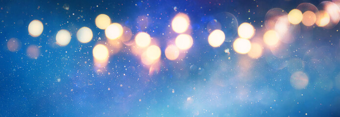 background of abstract glitter lights. blue, gold and silver. de focused. banner