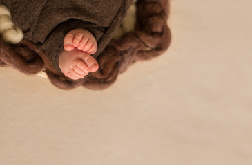Fototapeta na wymiar feet of the newborn baby, fingers on the foot, maternal care, love and family hugs, tenderness
