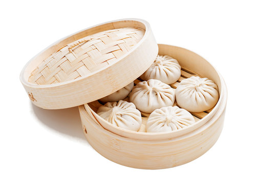 Raw dumplings Dim Sum in bamboo steamer. isolated on white background