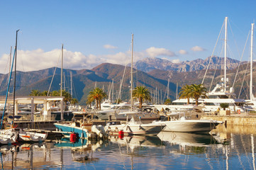 Fototapeta na wymiar Sunny winter day in yacht marina of Porto Montenegro. Montenegro, Tivat city, Kotor Bay of Adriatic Sea