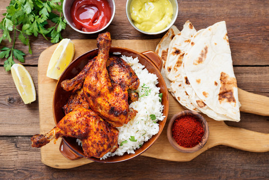 Tandoori chicken with jasmine rice and pita bread, indian cuisine.