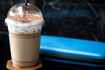 Iced coffee mocha with foam milk in takeaway cup