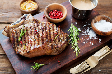 Fresh grilled meat. Grilled beef steak  on wooden cutting board.