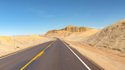 FPV HYPERLAPSE Driving along the empty road through grey sand desert canyon