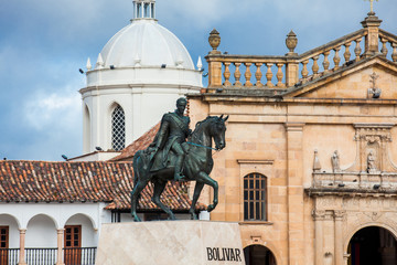 Historic equestrian monument to the Liberator Simon Bolivar with the Basilica of St. James the Apostle on background at the Bolivar Square in the Colombian city of Tunja