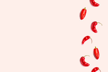 Minimal food concept. Creative layout of chili pepper on pink background.