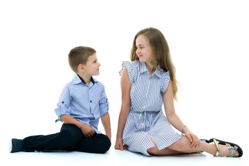 Brother and sister, boy and girl posing in the studio. Friendshi