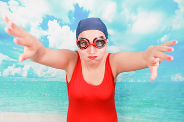 crazy diver in red swimsuit with swimming goggles on blue background. person swimmer learn to swim.