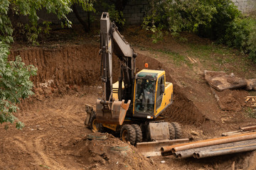 Fototapeta na wymiar Loader backhoe,excavator digging a trench,Work of excavating machine on building construction site