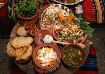 Freshly baked homemade bread arranged in traditional Bulgarian textiles. Image of some tasty Home-made bakery products. Fresh bread,brown, wheat, sliced, round, product, bagel, delicious, baking.