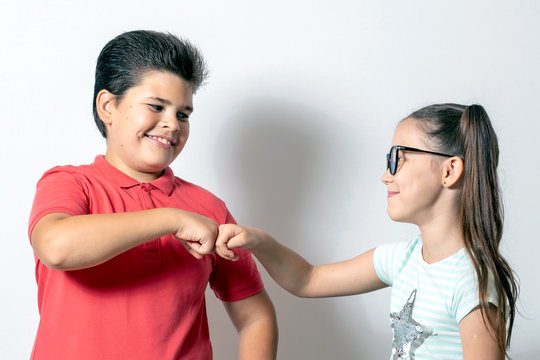 Children shake hands, brother and sister conceived something cunning and insidious