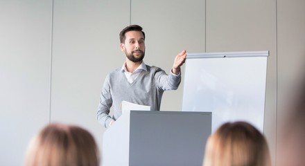 Businessman asking question to colleagues in office