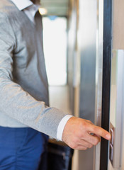 Close up of Businessman pressing elevator button