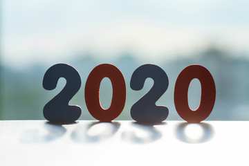 Happy New Year 2020. The number 2020 is written in wooden toy numbers. Beautiful card for the...