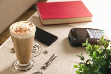 Payment machine and smartphone on the table in cafe, nfc payment concept