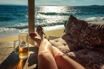 aegean, aretes, bar, beach, beautiful, beer, blue, blurred background, chalkidikí, coastline, destination, feet on table, female, foam, girl, glass, golden, greece, holiday, horizon, legs, mediterrane