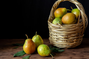 Basket with pears on a wooden table