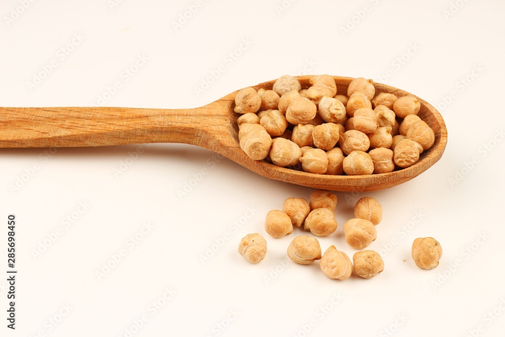 Canvas Prints chickpeas in a spoon on a white background closeup