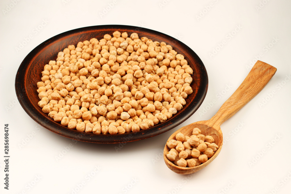 Poster chickpeas in a plate and spoon on a white background